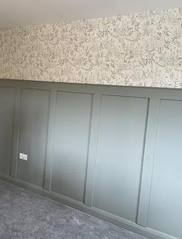 Panelling and detailed wallpaper to bedroom wall
